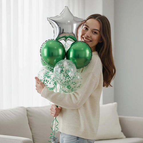 1 Silver Star Balloon with 2 Green Round Helium Foil Balloons & 3 Green Confetti Balloons held by a model, view 1