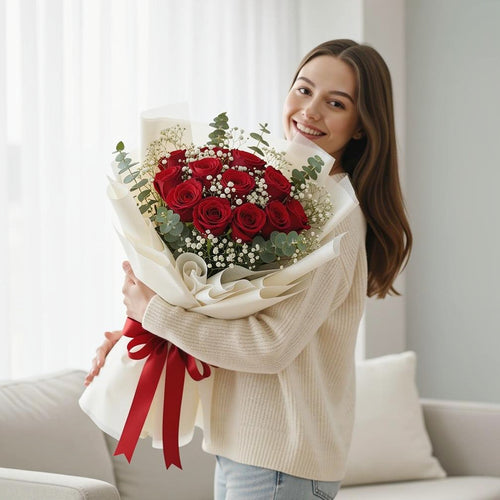 12 Red Rose Bouquet for Anniversary held by a model, view 1