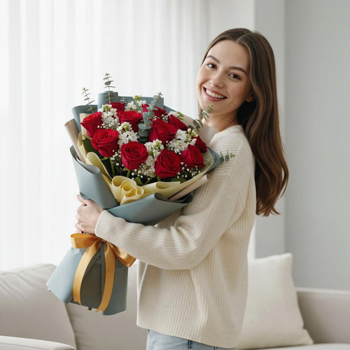 12 Red Roses & White Matthiola Bouquet for Anniversary held by a model, view 1