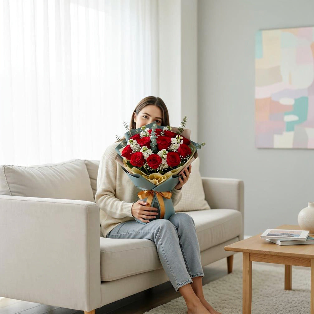 12 Red Roses & White Matthiola Bouquet for Anniversary held by a model, view 3