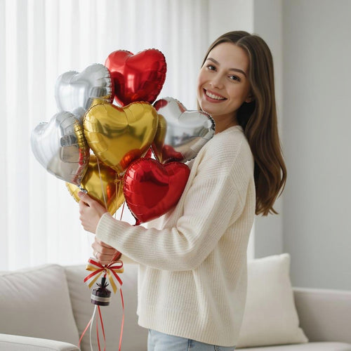 2 Silver, 2 Golden & 3 Red Heart-Shaped Helium Foil Balloons Set held by a model, view 1