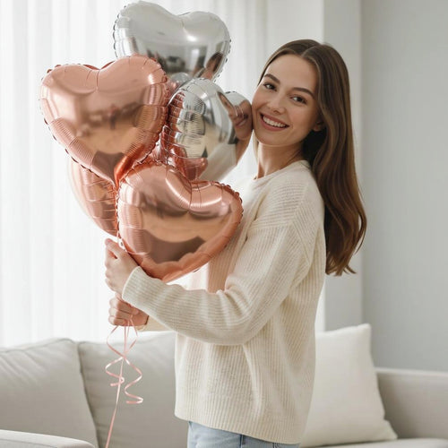 2 Silver & 3 Rose Gold Heart-Shaped Helium Foil Balloons held by a model, view 1