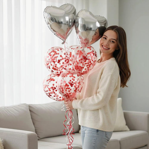 2 Silver Balloons with 6 Red Confetti Balloons held by a model, view 1