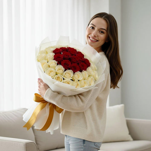 32 Red & White Rose Bouquet for Anniversary held by a model, view 1