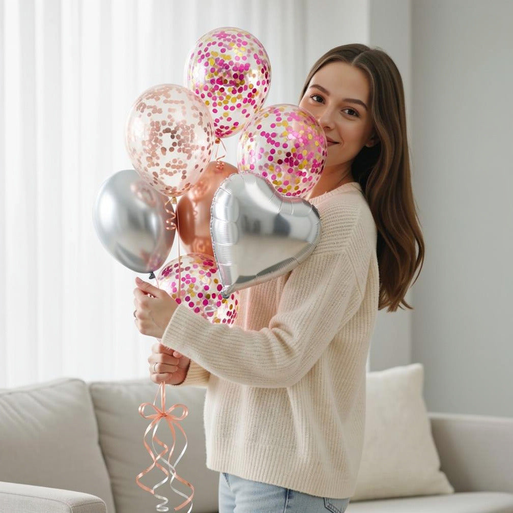 5 Rose Gold & Pink Confetti Balloons with 2 Round & 1 Heart Silver Foil Helium Balloons held by a model, view 1
