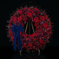 Circular Sympathy Wreath with Burgundy, Crimson & Purple Flowers, Calla Lilies, Roses & Blue Velvet Bow on Easel Stand bloomsandbeansae