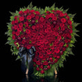Heart-Shaped Funeral Arrangement with Red Roses, Green Foliage & Black Bow bloomsandbeansae