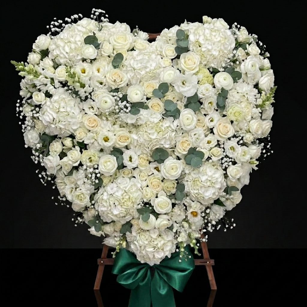 Heart-Shaped Funeral Wreath with White Roses, Hydrangeas, Baby’s Breath & Green Satin Bow bloomsandbeansae