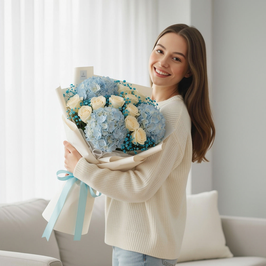 Blue Hydrangea & White Rose Bouquet for Birthday held by a model, view 1
