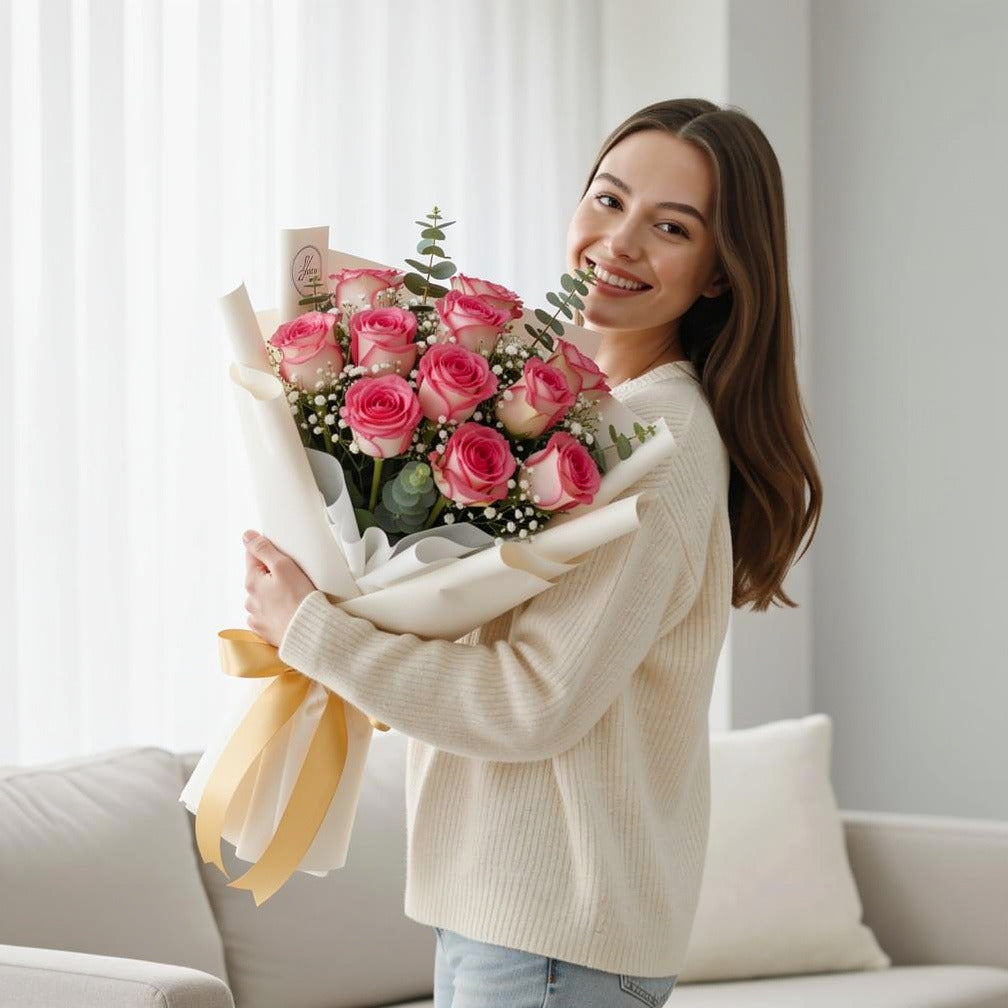 Blush Success Pink Roses Graduation Bouquet held by a model, view 1