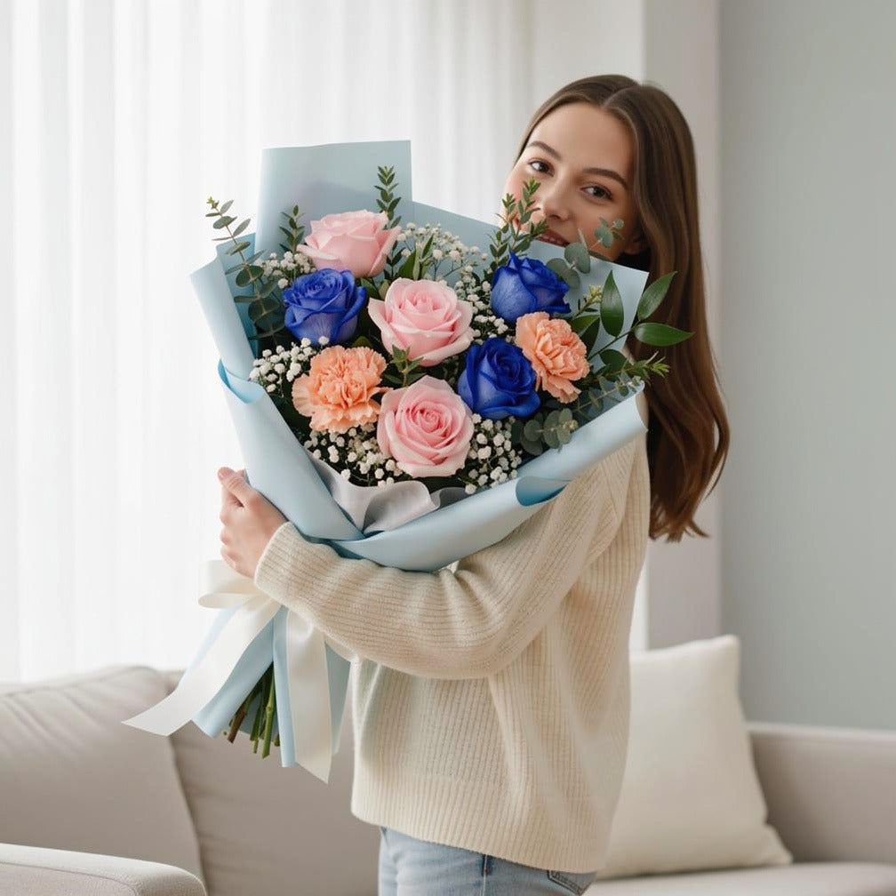 Bouquet of Pink & Blue Roses with Peach Carnations for Father’s Day held by a model, view 1