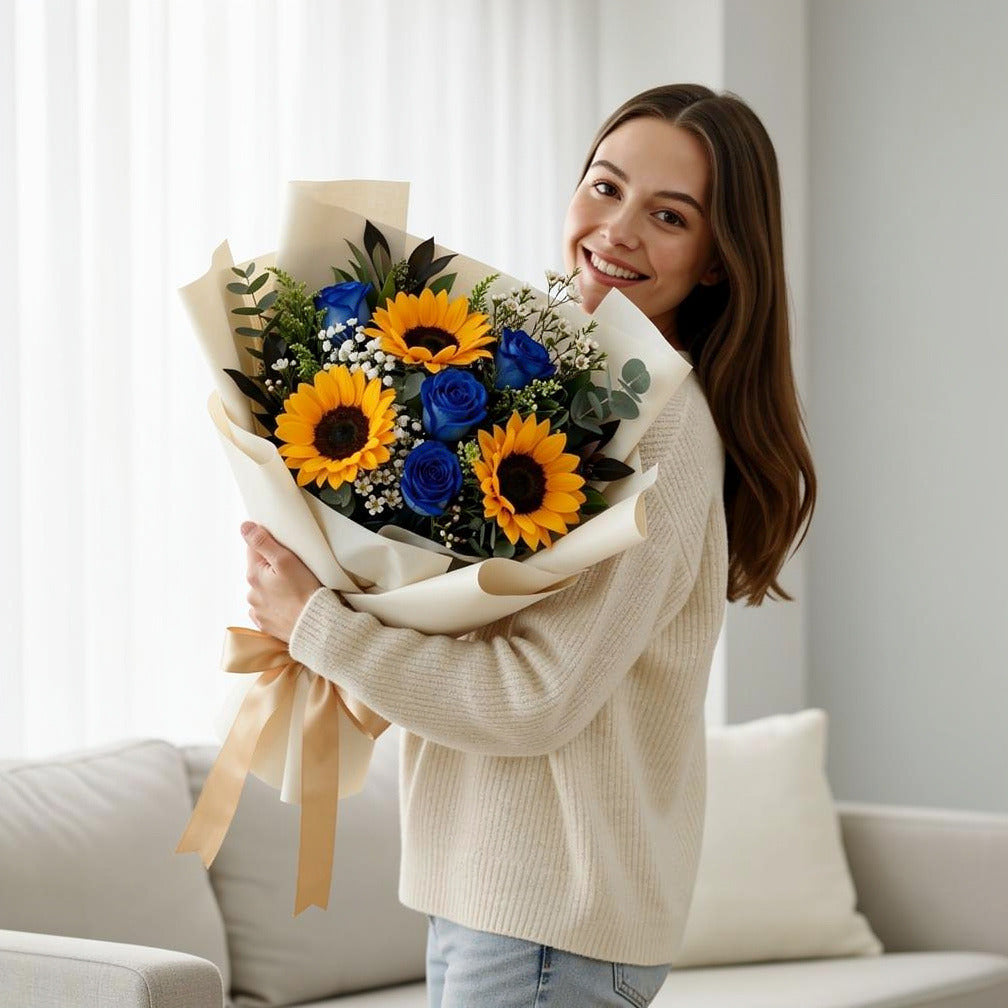 Bright Sunflower & Blue Rose Bouquet held by a model, view 1