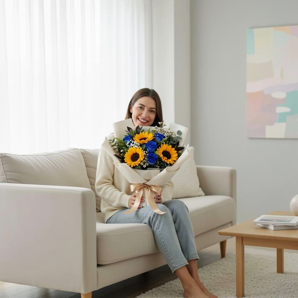 Bright Sunflower & Blue Rose Bouquet held by a model, view 3