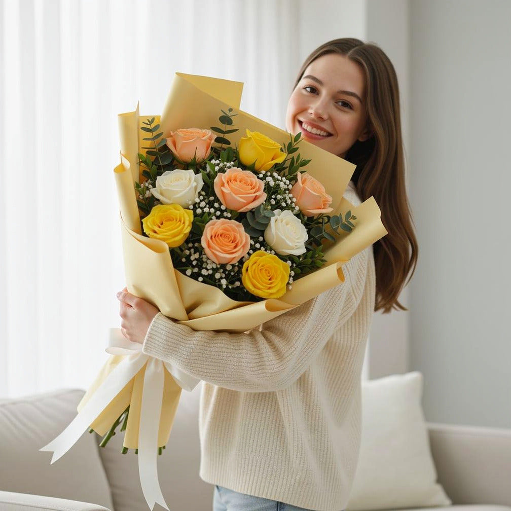Eid Bright Bouquet of Yellow, White & Peach Roses held by a model, view 1