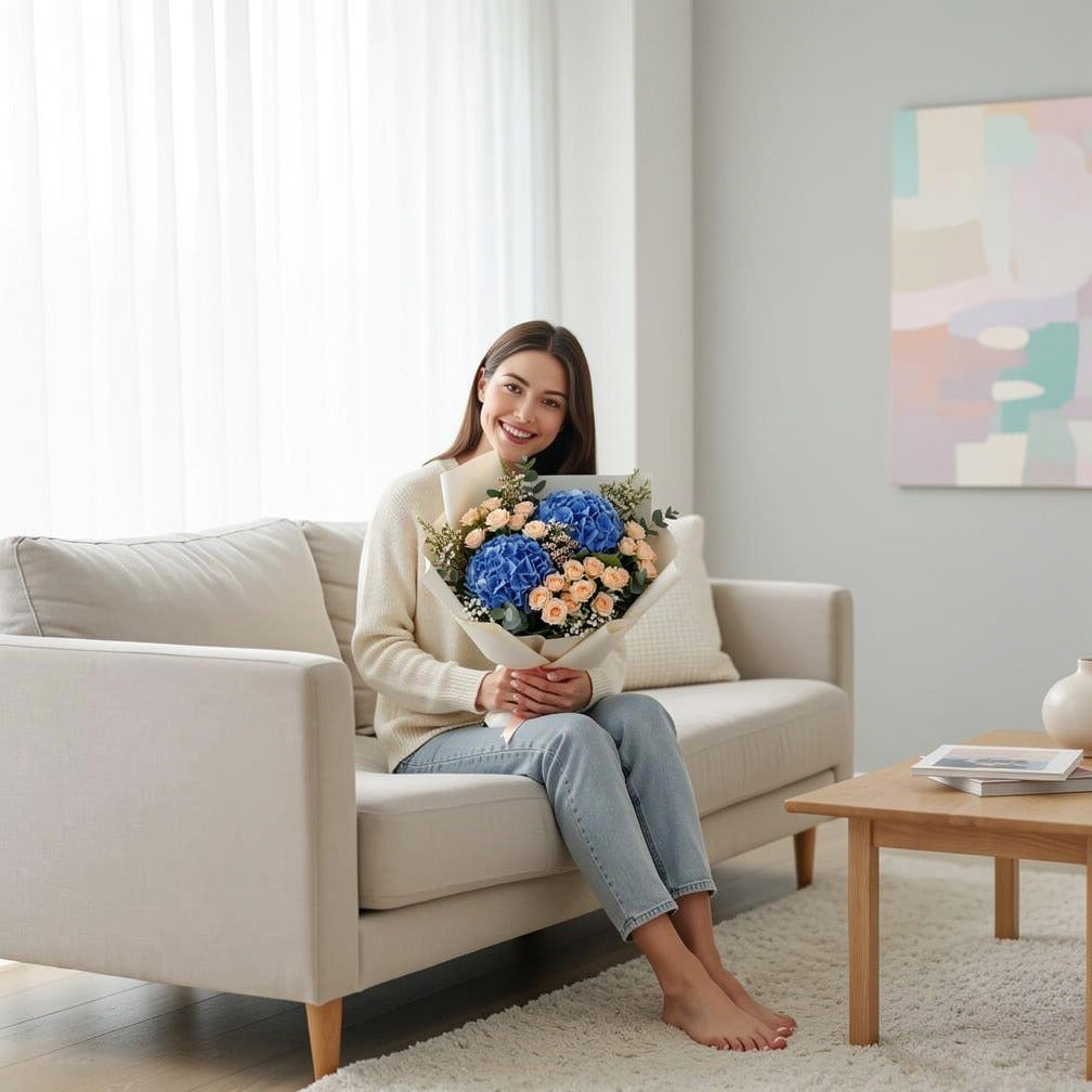 Elegant Blue Hydrangea & Peach Baby Rose Bouquet held by a model, view 3