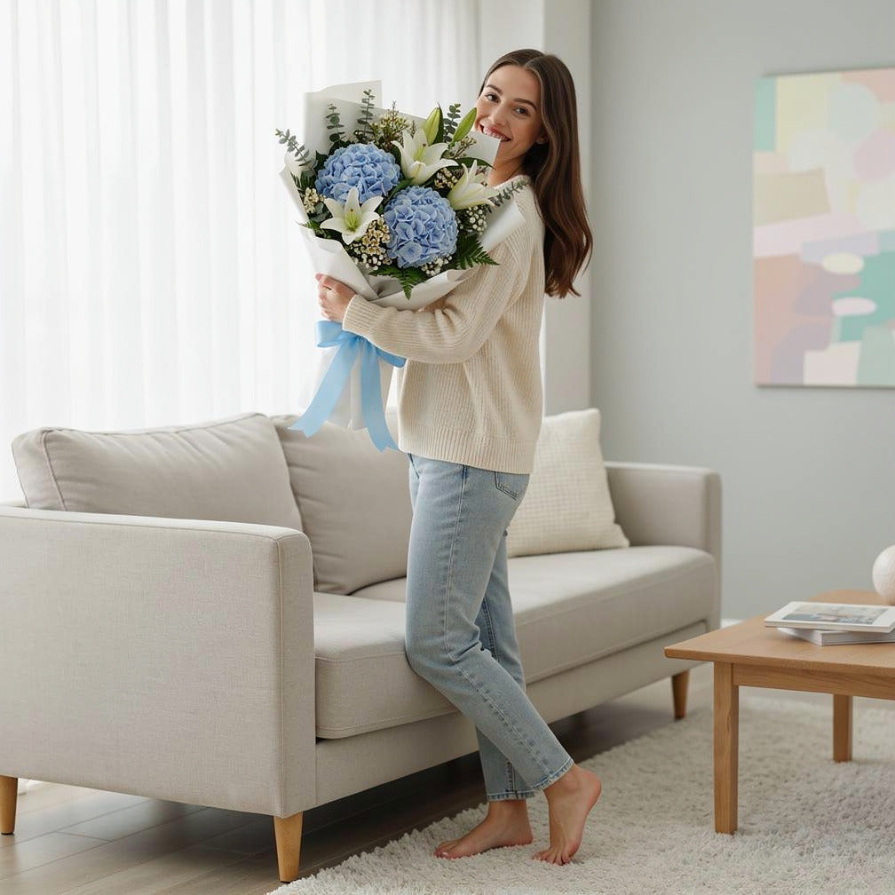 Elegant Bouquet of Blue Hydrangea & White Lilies for Father’s Day held by a model, view 2