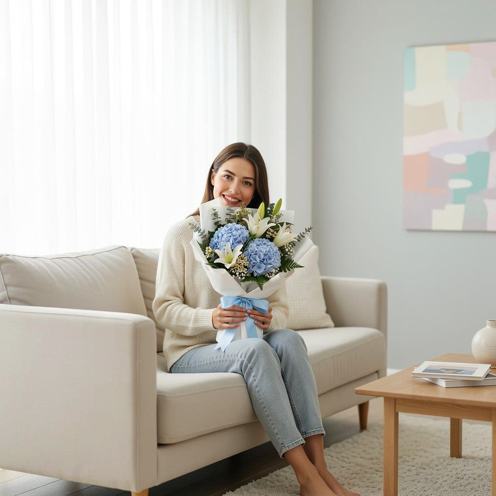 Elegant Bouquet of Blue Hydrangea & White Lilies for Father’s Day held by a model, view 3