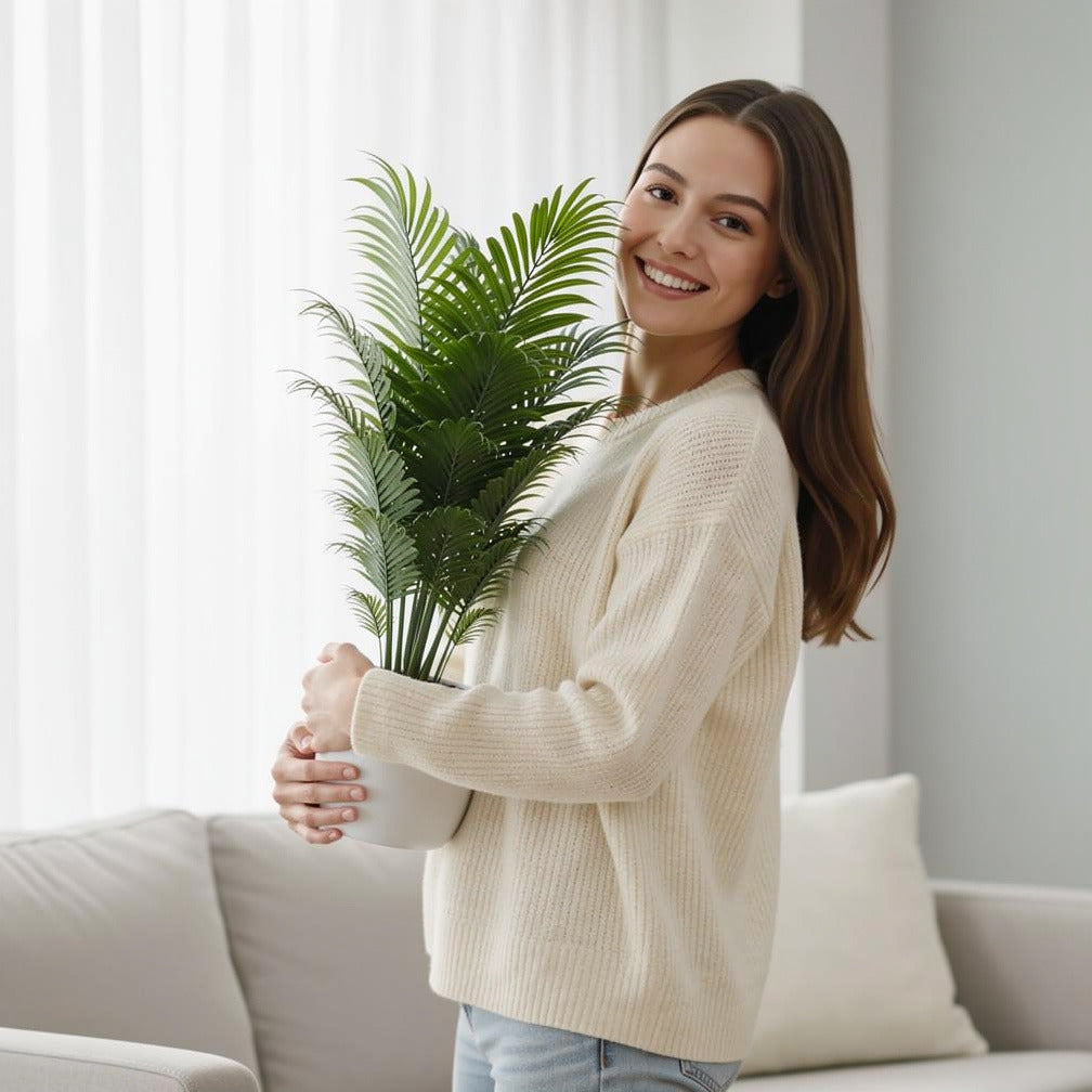 Elegant Small Palm Plant held by a model, view 1
