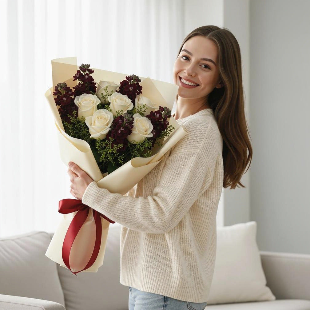 Elegant White Roses & Red Matthiola Bouquet held by a model, view 1