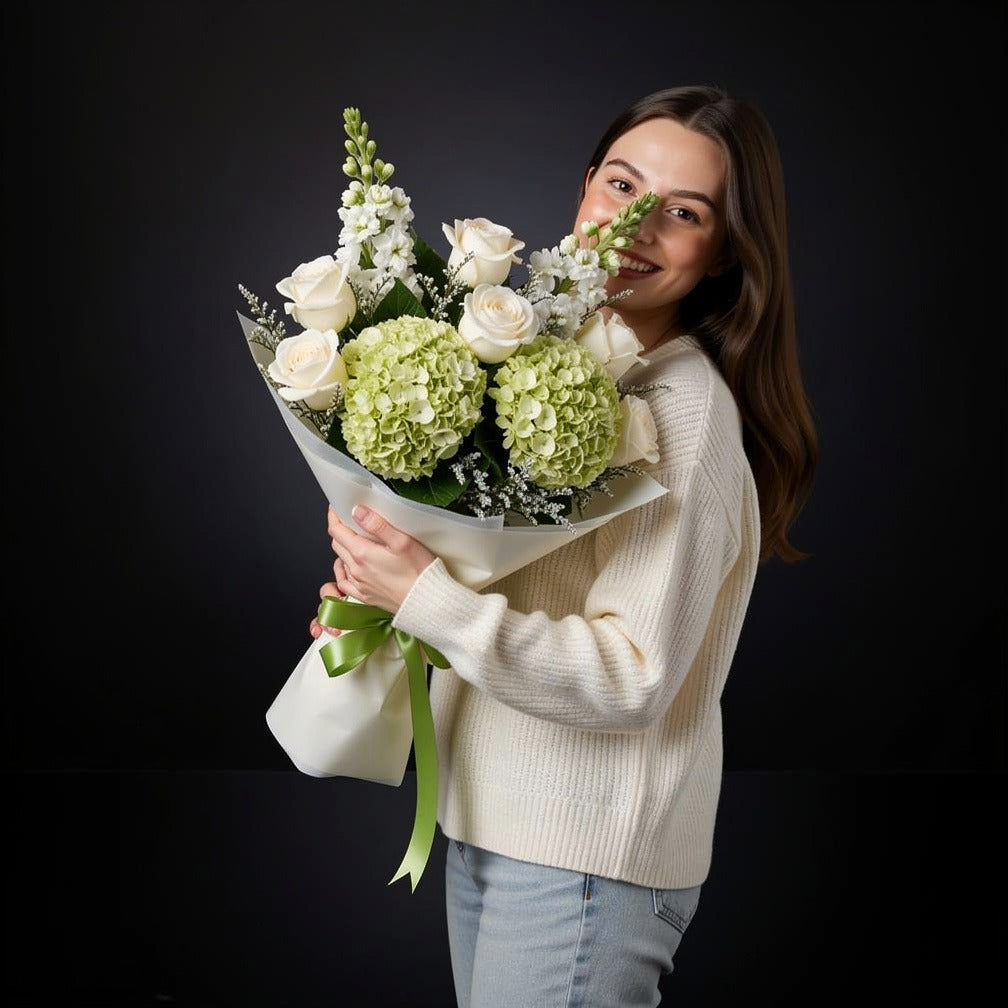 Green Hydrangea & White Roses Graduation Bouquet held by a model, view 1