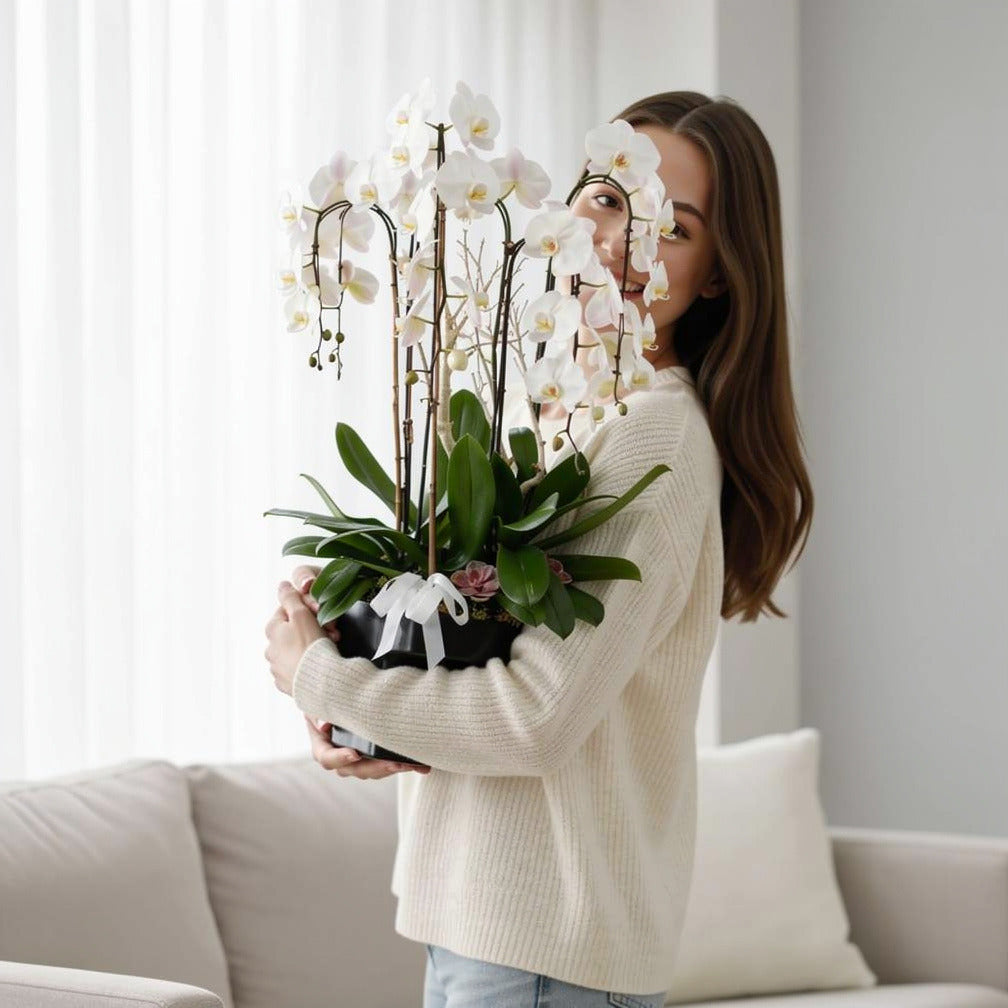 Luxury 7 White Orchids Plants held by a model, view 1