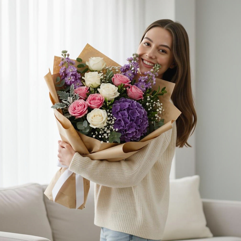 Mother’s Day Elegant Pink, White & Purple Mixed Bouquet held by a model, view 1