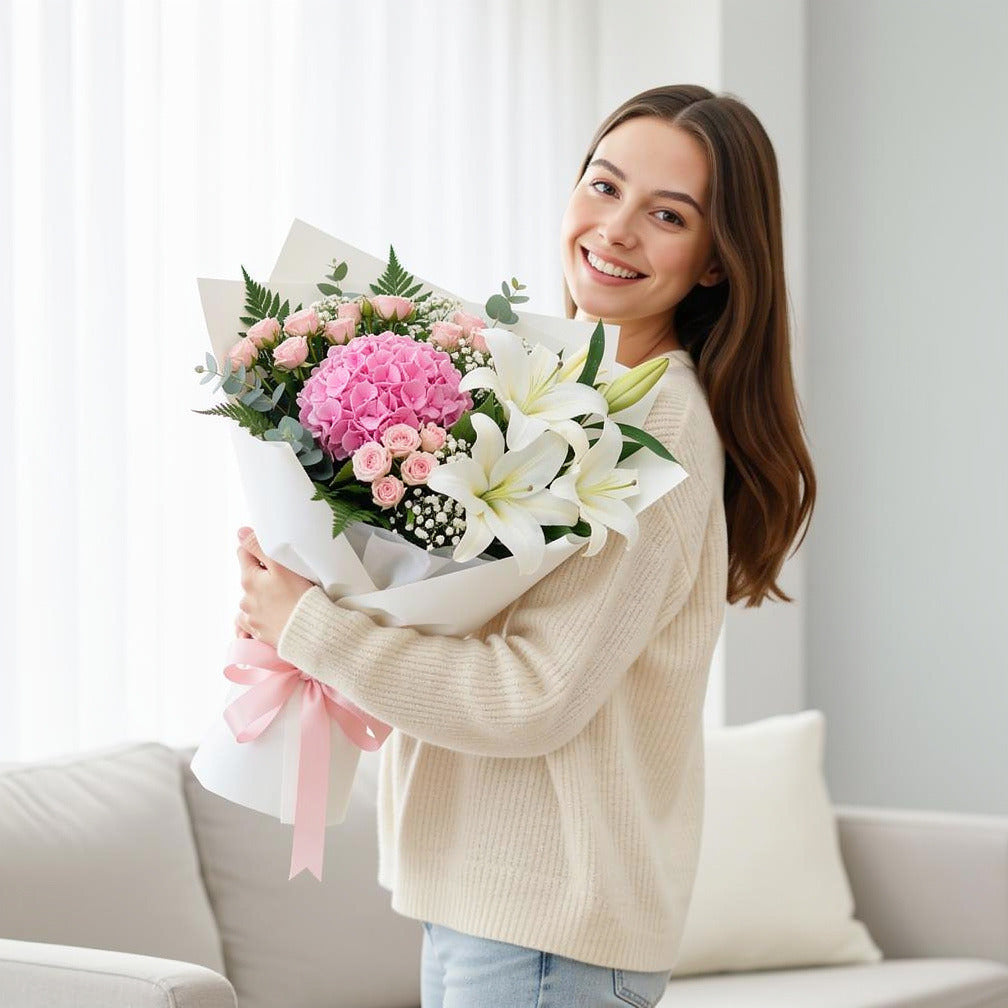 Mother’s Day Soft Pink Hydrangea & Lily Bouquet held by a model, view 1