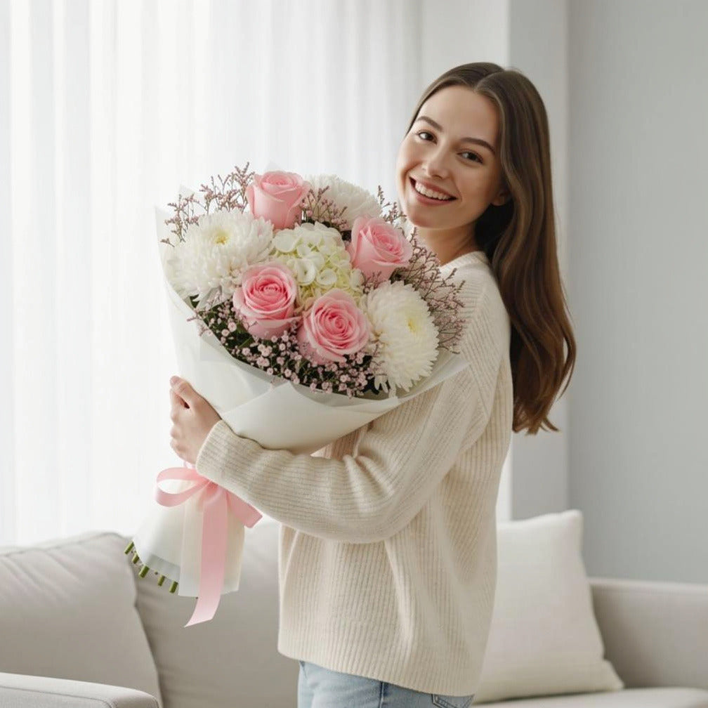 Pink Roses, Chrysanthemum & Hydrangea Bouquet for Anniversary held by a model, view 1