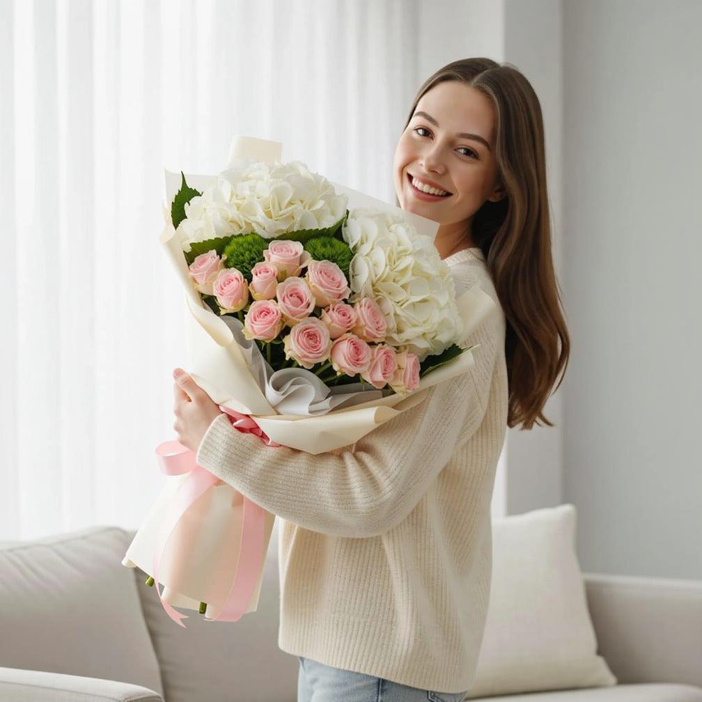 Pink Roses & White Hydrangea Bouquet for Birthday held by a model, view 1