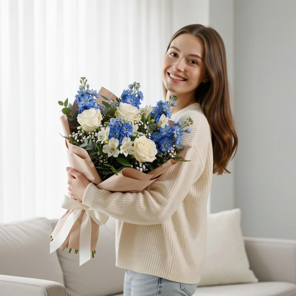 Serenity Bouquet of White Roses, Matthiola & Alstroemeria held by a model, view 1