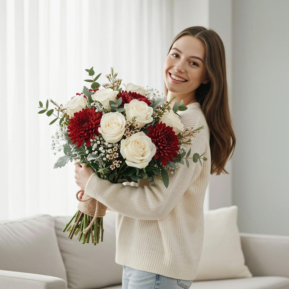 Striking Bridal Bouquet of White Roses & Red Chrysanthemums held by a model, view 1