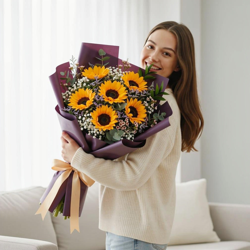 Sunshine Eid Bouquet of 6 Sunflowers held by a model, view 1