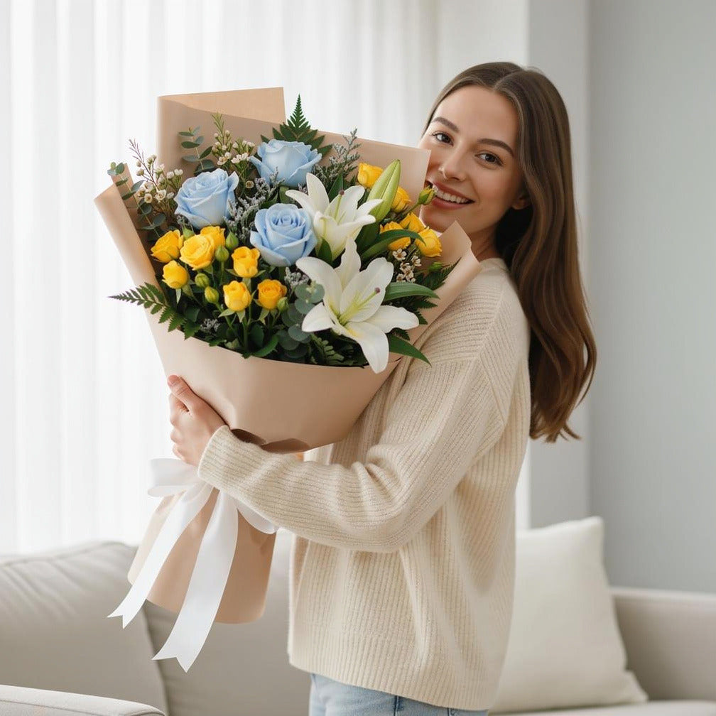 Teacher’s Day Calm Blue & White Lily Mixed Bouquet held by a model, view 1