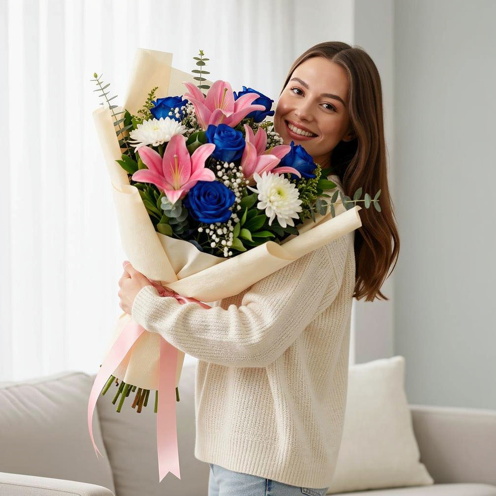 Teacher’s Day Elegant Blue Rose & Pink Lily Bouquet held by a model, view 1