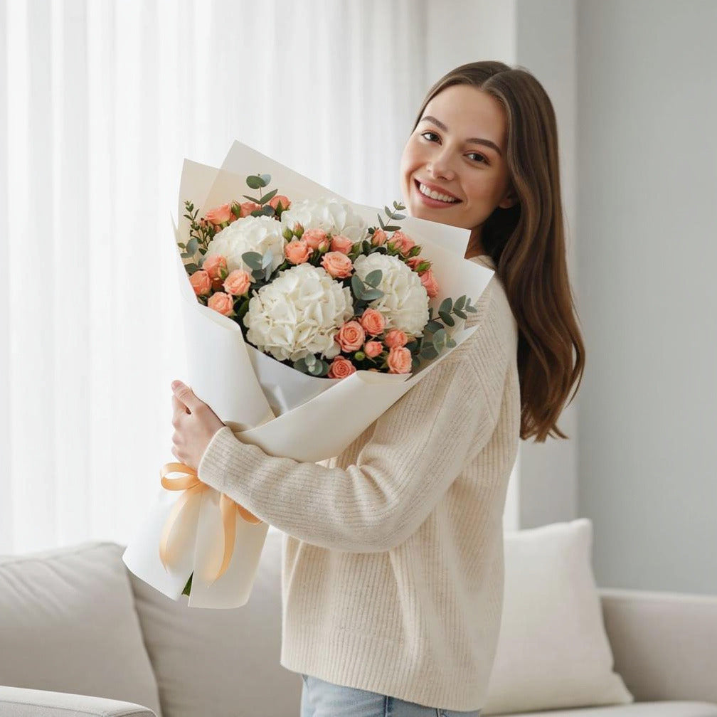 Teacher’s Day Graceful Hydrangea & Peach Rose Bouquet held by a model, view 1