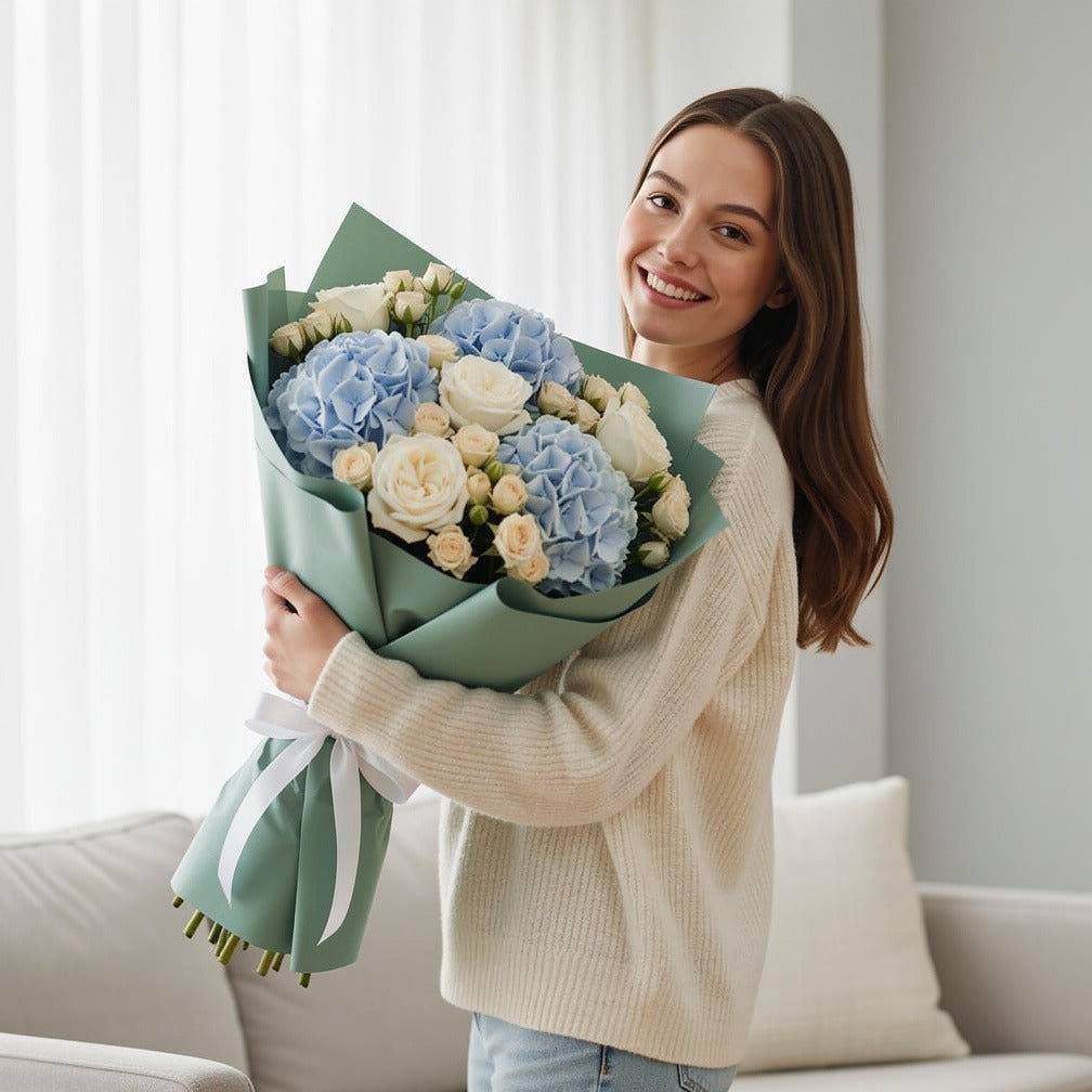 Teacher’s Day Ocean Breeze Hydrangea & Rose Bouquet held by a model, view 1