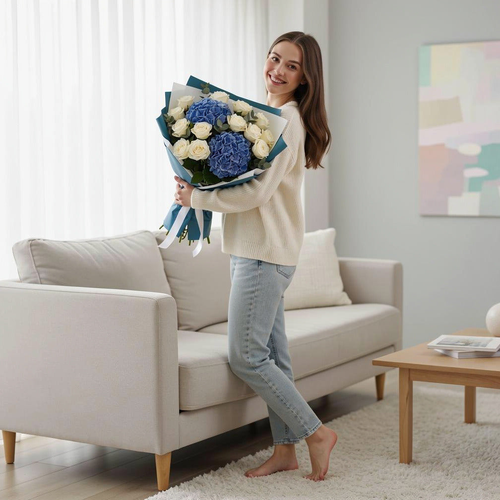 Teacher’s Day Royal Blue Hydrangea & White Rose Bouquet held by a model, view 2