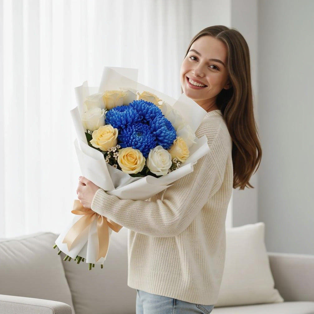 Teacher’s Day White & Yellow Rose with Blue Chrysanthemum Bouquet held by a model, view 1