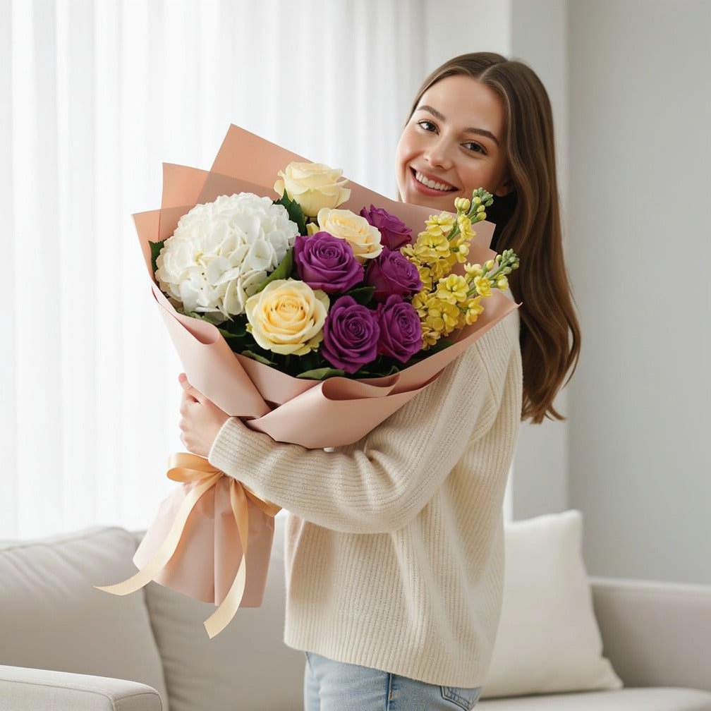 Women’s Day Bright Yellow & Purple Hydrangea Rose Bouquet held by a model, view 1