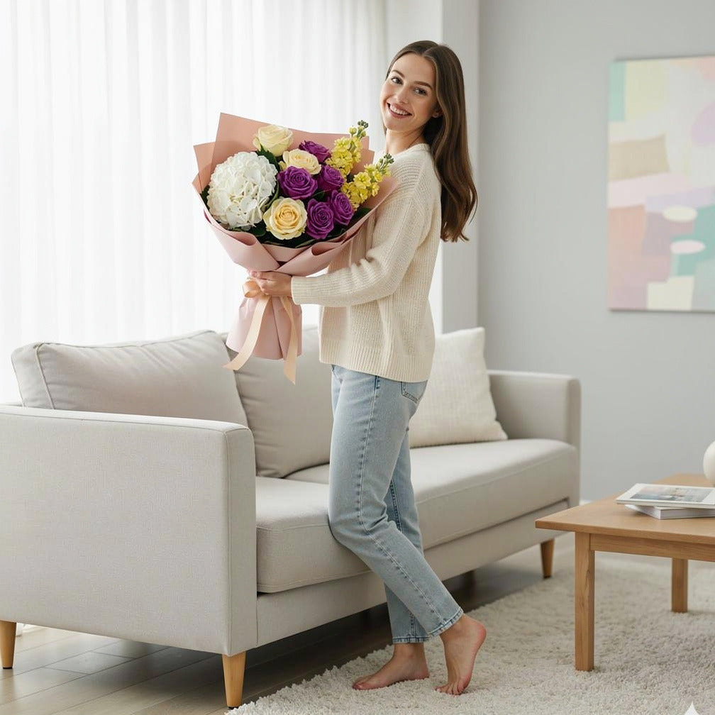 Women’s Day Bright Yellow & Purple Hydrangea Rose Bouquet held by a model, view 2