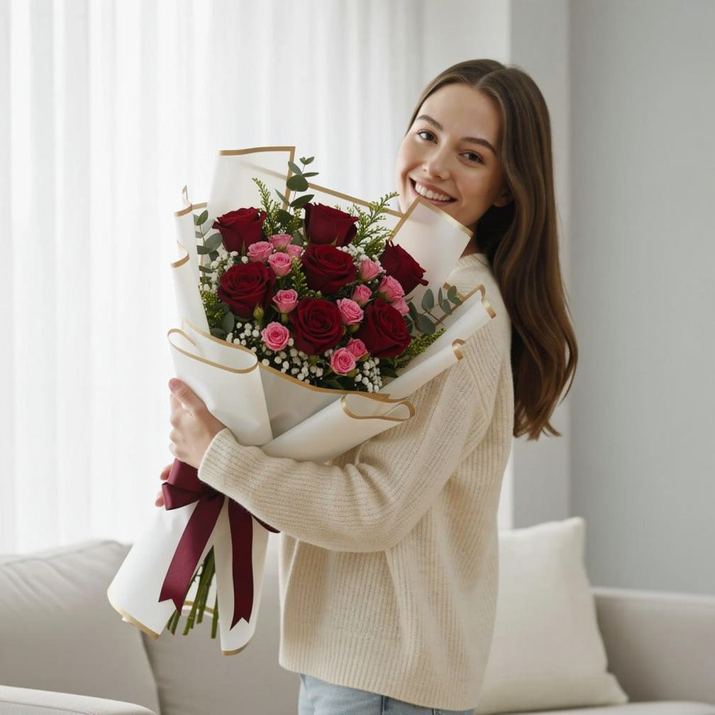 Women’s Day Red & Pink Rose Celebration Bouquet held by a model, view 1