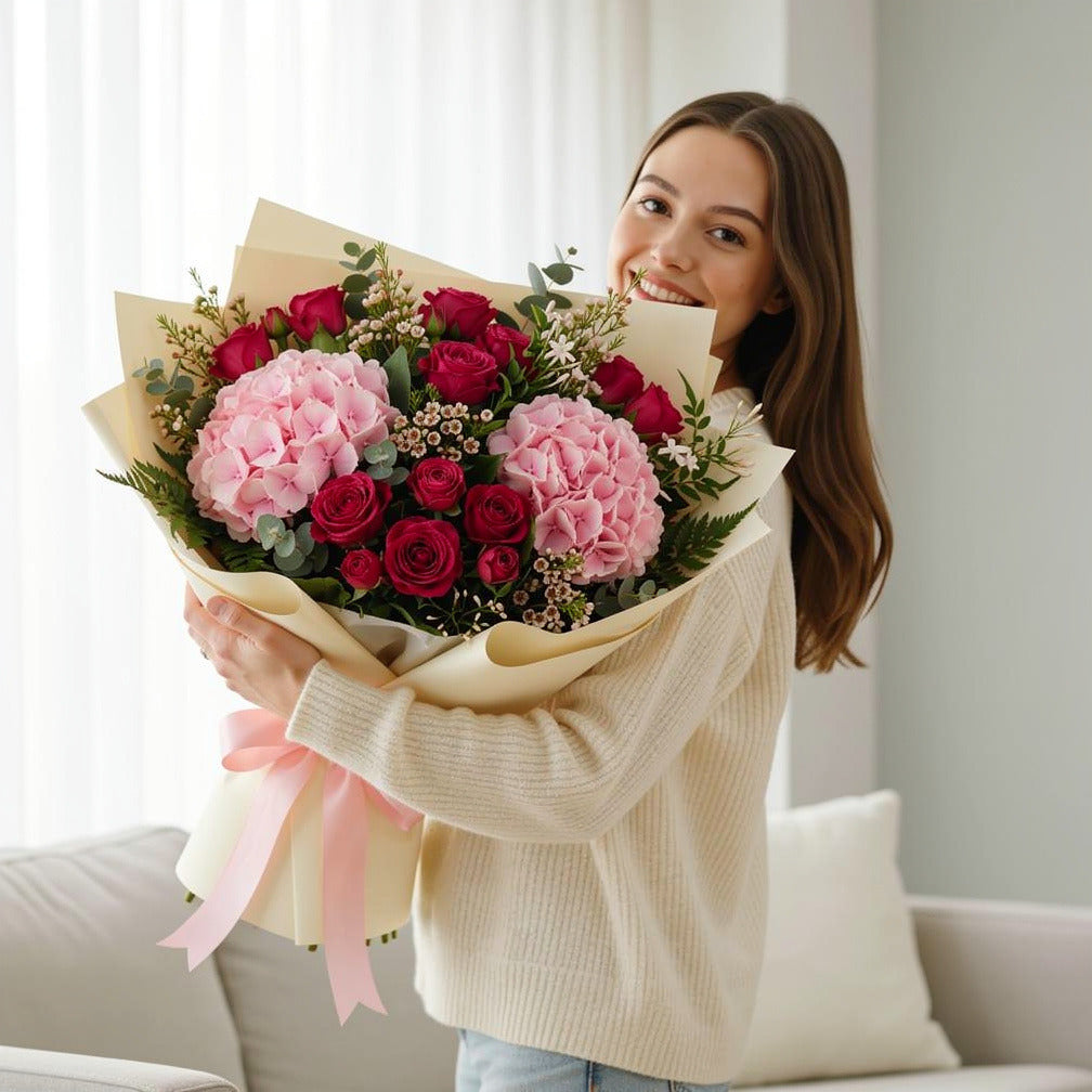 Women’s Day Soft Pink Hydrangea & Baby Rose Bouquet held by a model, view 1