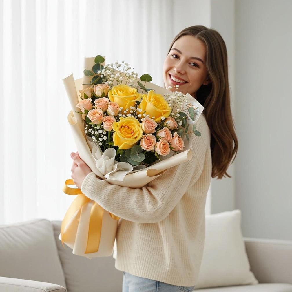 Yellow & Peach Roses Golden Milestone Bouquet held by a model, view 1