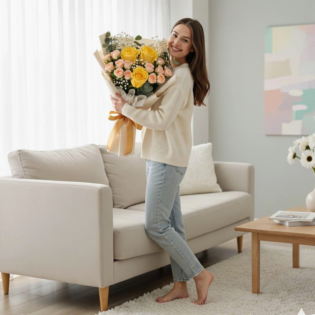 Yellow & Peach Roses Golden Milestone Bouquet held by a model, view 2